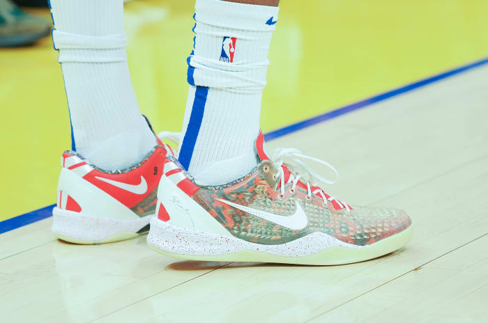 View of white and red Nike Kobe shoes.